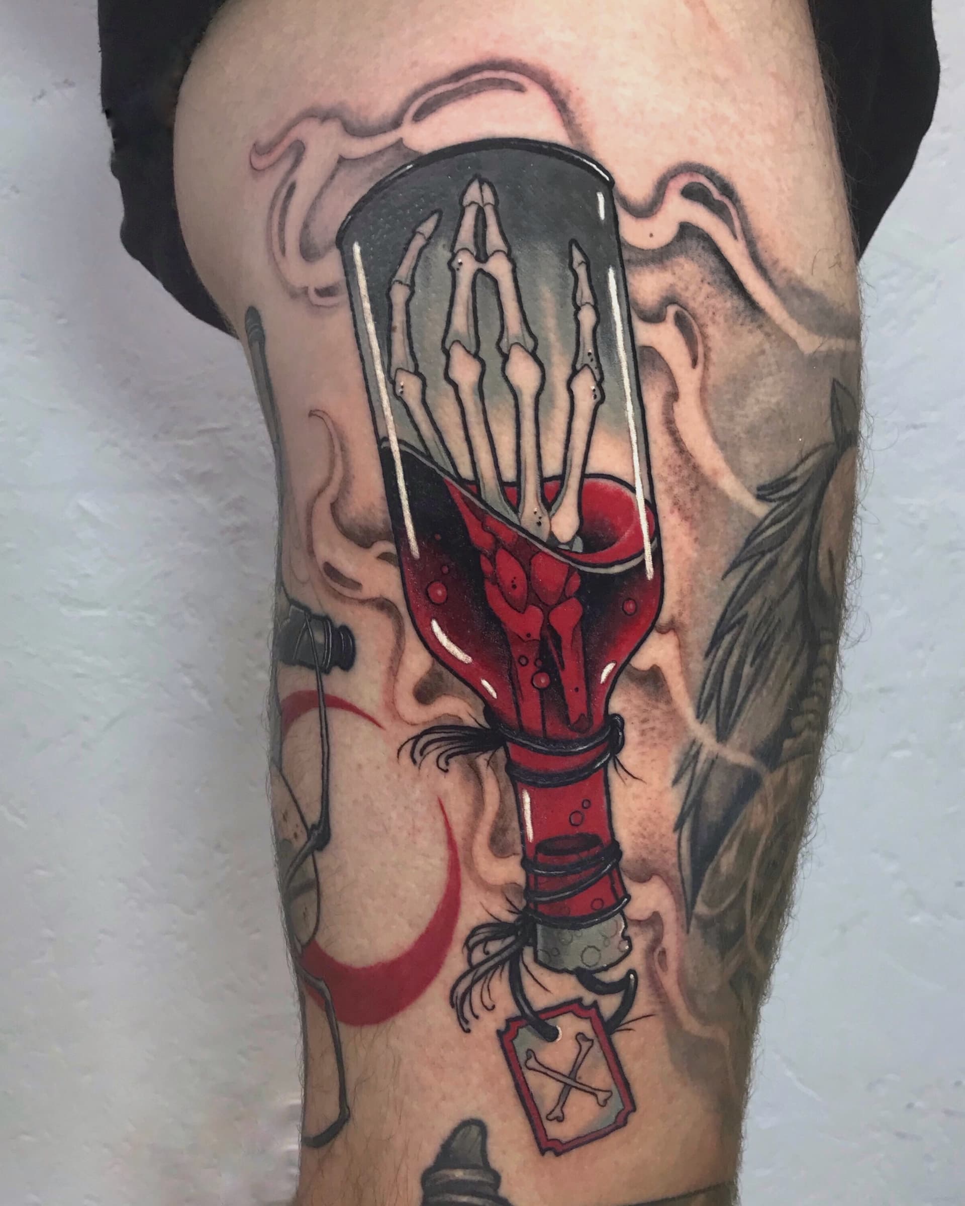 Skeleton hand in potion bottle tattoo — fantasy neo-traditional work by Vancouver artist Seth Zuiev