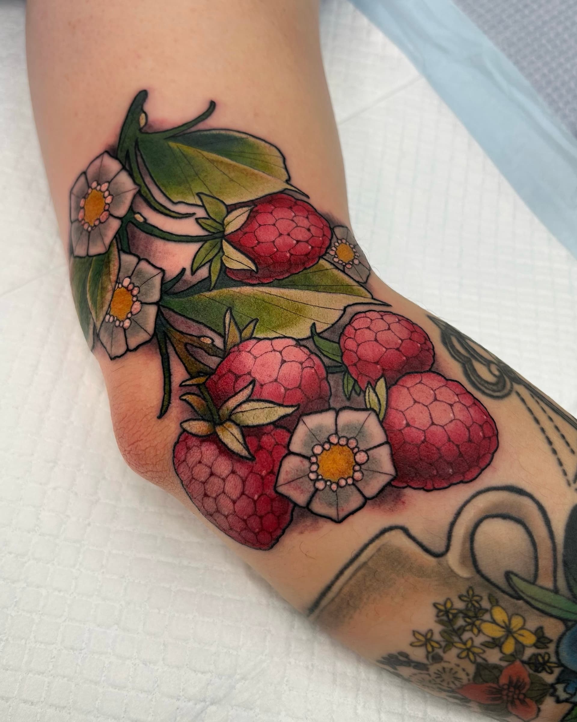Botanical raspberry and flowers tattoo by Seth Zuiev — colorful Vancouver neo-traditional tattoo art